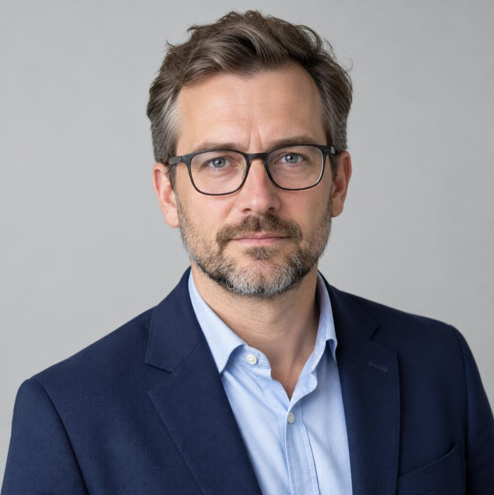 Studio portrait of a European man editor with glasses